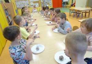 Grupa dzieci je kulki czekoladowe.